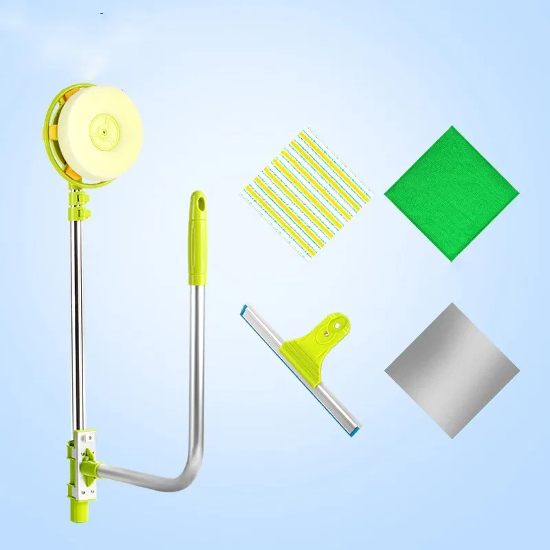 Green telescopic glass wiper with extendable handle resting on a windowsill