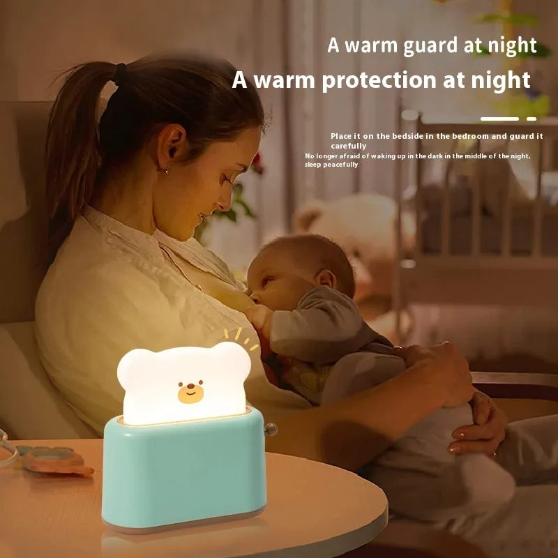 Bread bear shaped silicone night light with warm yellow glow on a desk
