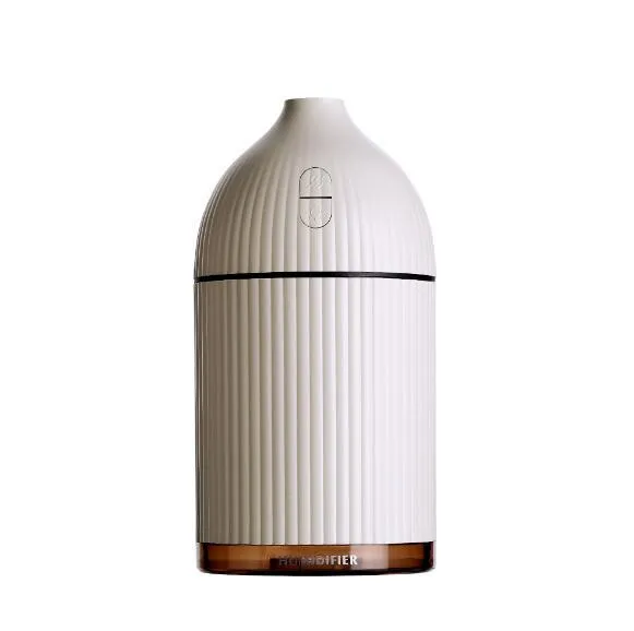 White USB-powered ultrasonic aromatherapy diffuser and humidifier with LED light on a wooden surface.