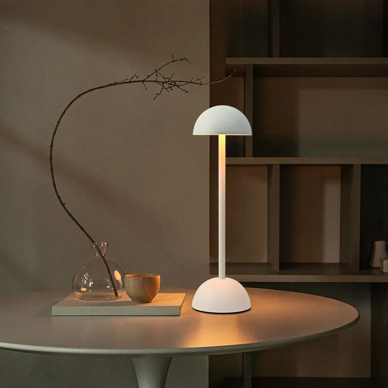 Metal mushroom table lamp in high foot design with white finish on a bar table