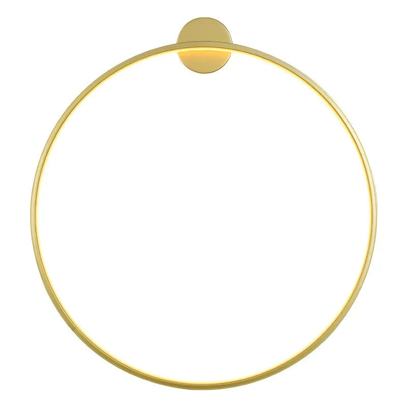 Minimalist black ring wall lamp with acrylic shade mounted on a bedroom wall