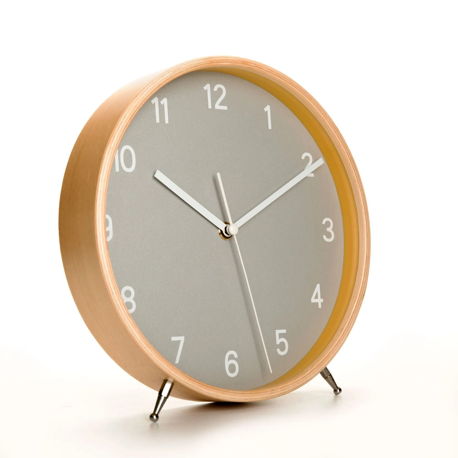 Round wood quartz table clock with sweep second movement in green finish on a wooden surface