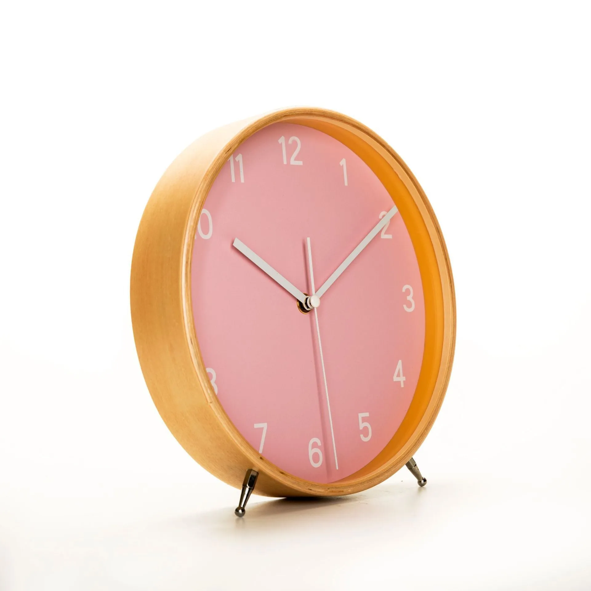 Round wood quartz table clock with sweep second movement in green finish on a wooden surface
