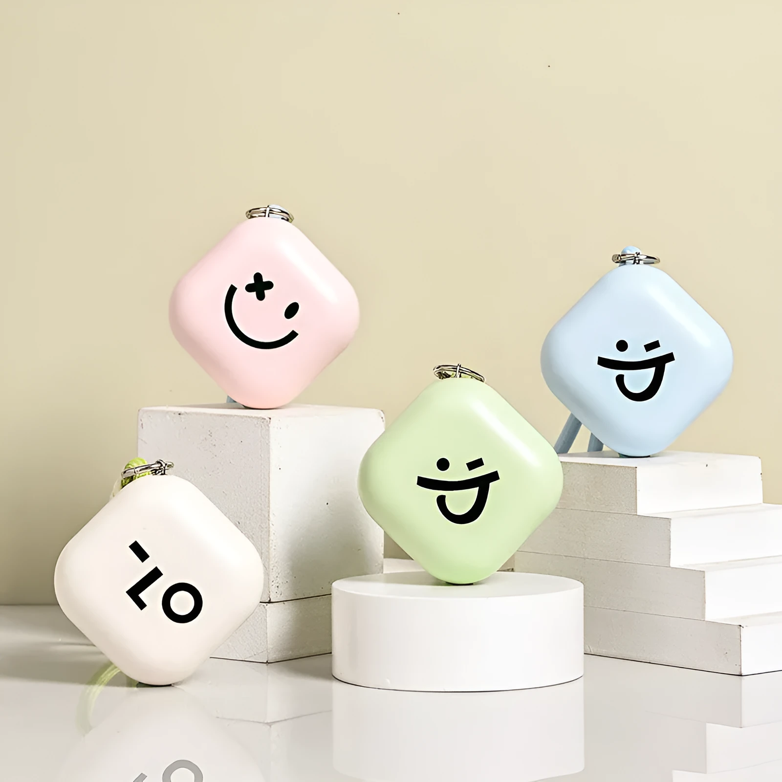 Square rechargeable hand warmer in white, light green, and pink colours with USB charging
