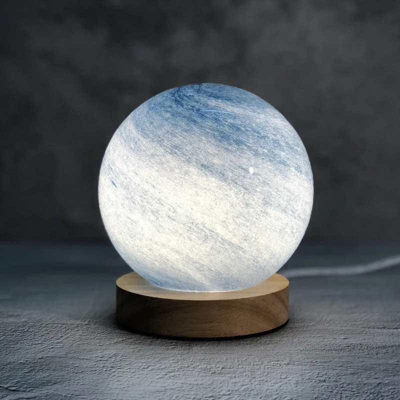Nordic style Planet Light table lamp with transparent glass shade, shown in emerald green colour.