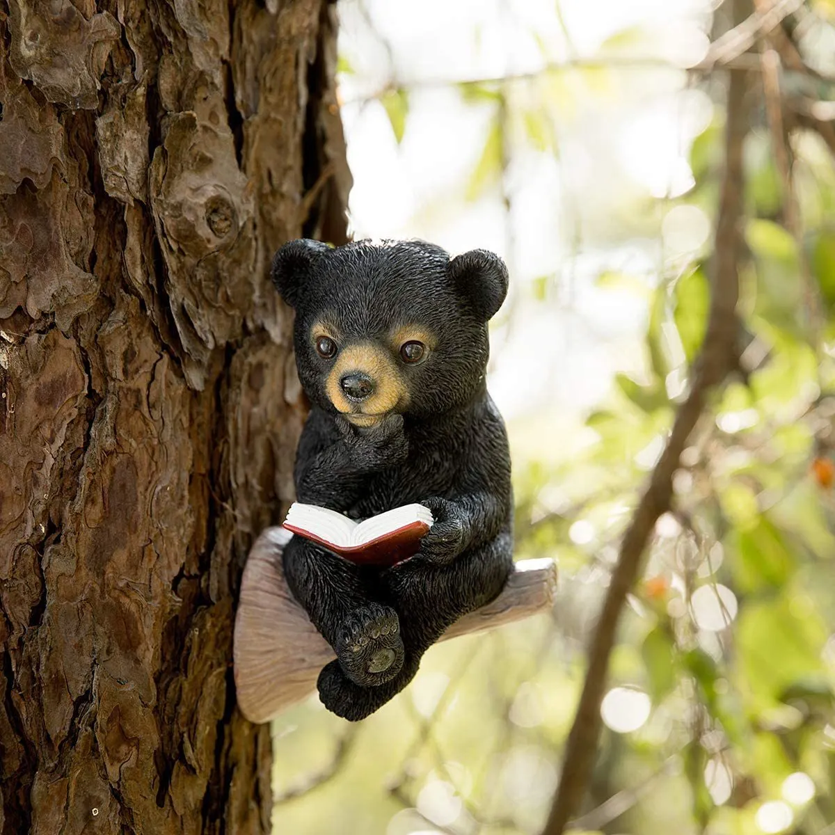 Black bear solar light ornament in synthetic resin placed in garden with solar panel on top