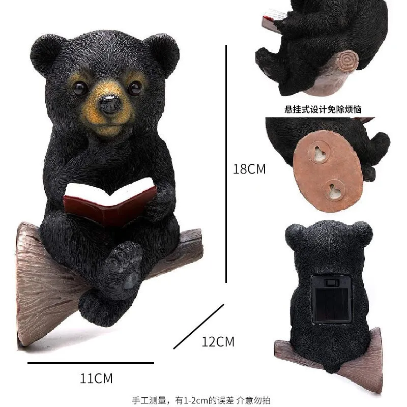 Black bear solar light ornament in synthetic resin placed in garden with solar panel on top