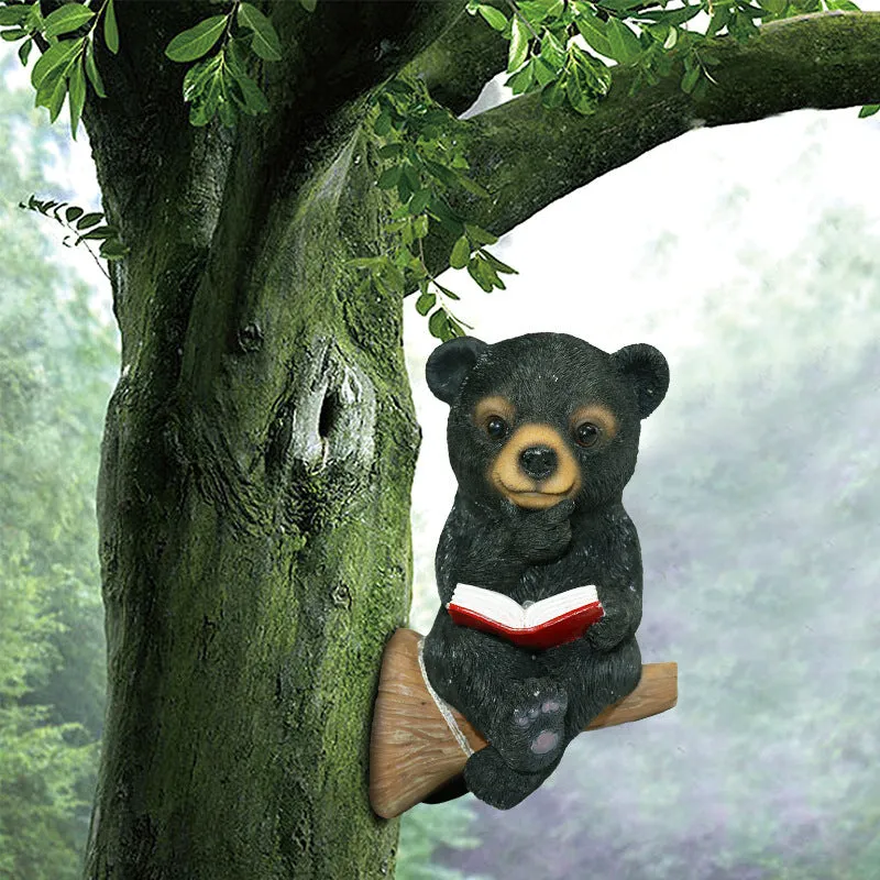 Black bear solar light ornament in synthetic resin placed in garden with solar panel on top