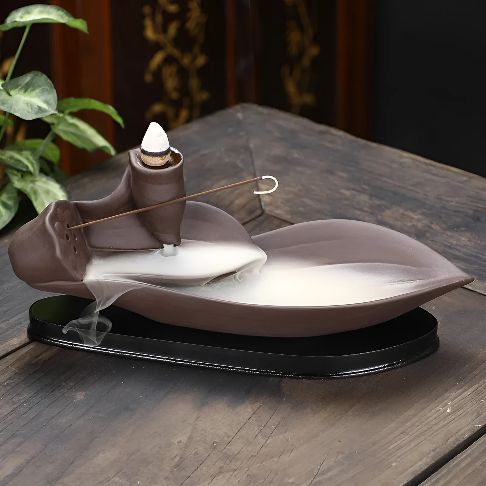 Brown purple sand backflow incense burner 21cm long on flat surface