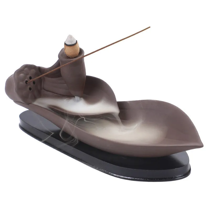 Brown purple sand backflow incense burner 21cm long on flat surface