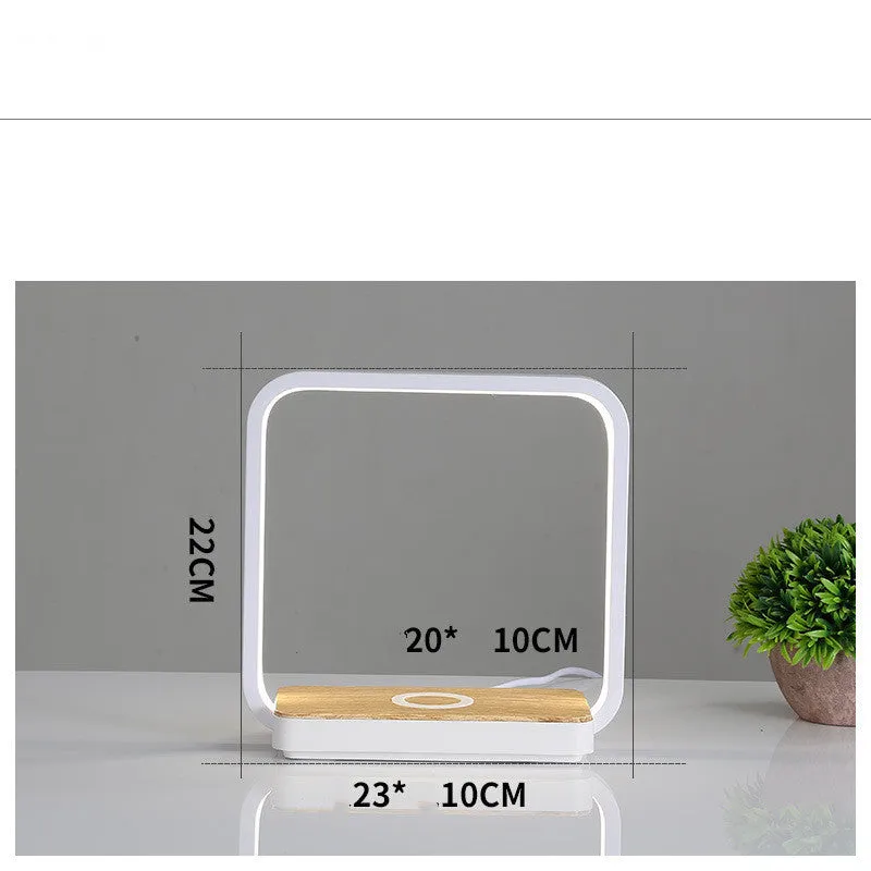 Modern white smart bedside lamp with touch control and USB cable on a wooden nightstand.