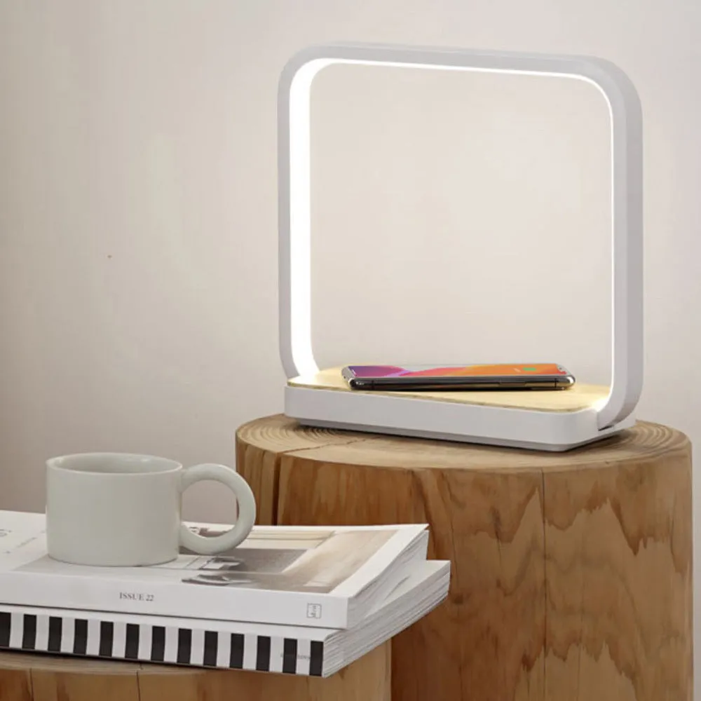 Modern white smart bedside lamp with touch control and USB cable on a wooden nightstand.