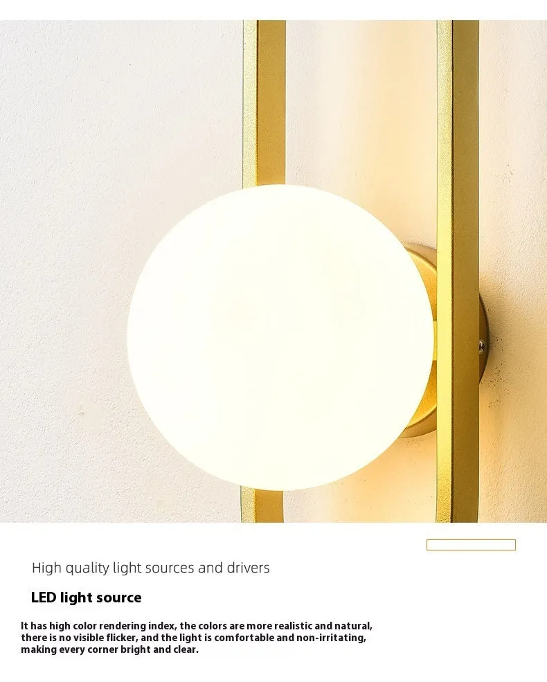 Minimalist wall-mounted lamp with clear glass bulb shade on a black iron sconce arm and backplate.