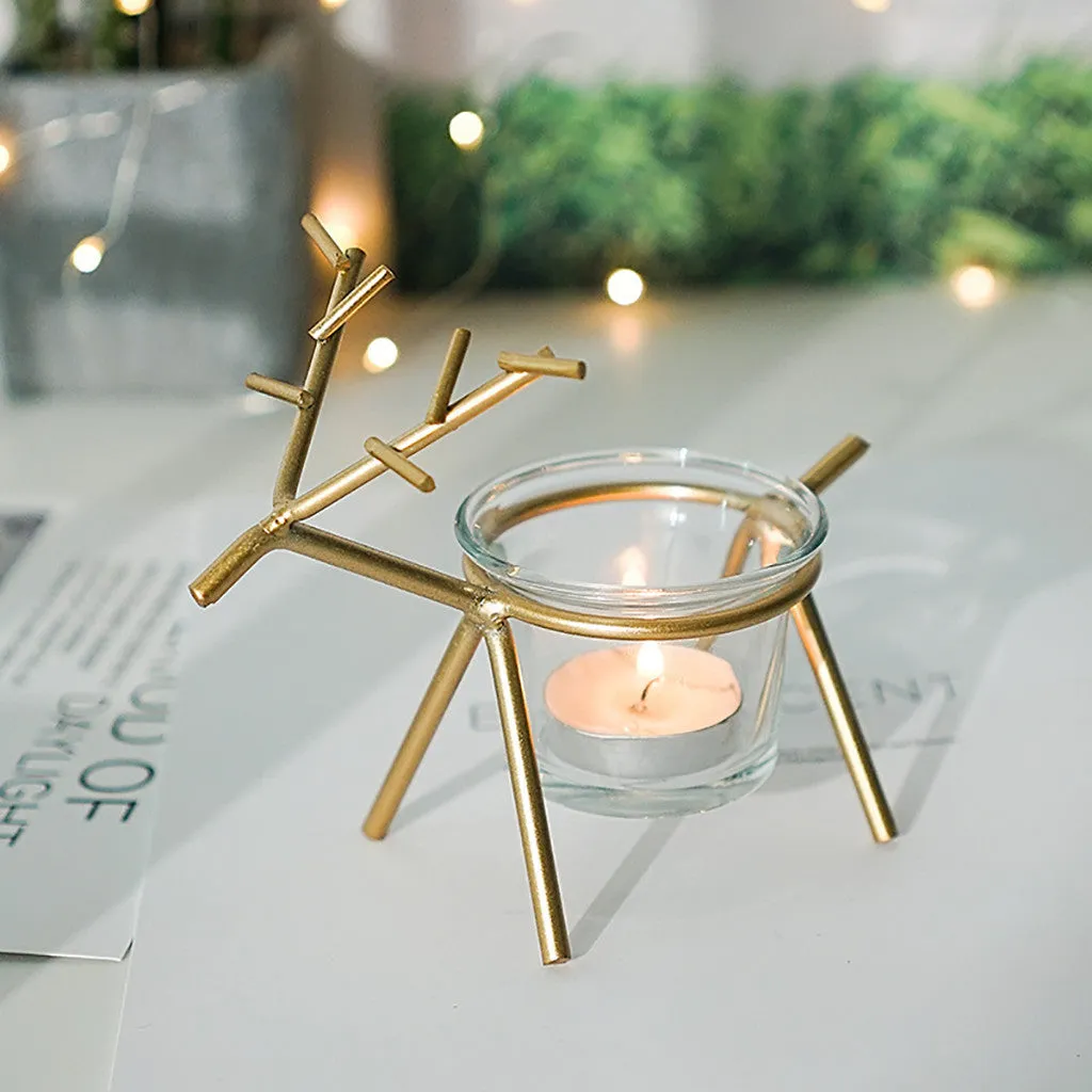 Wrought iron fawn candle holder with glass cup in gold electroplated finish on tabletop