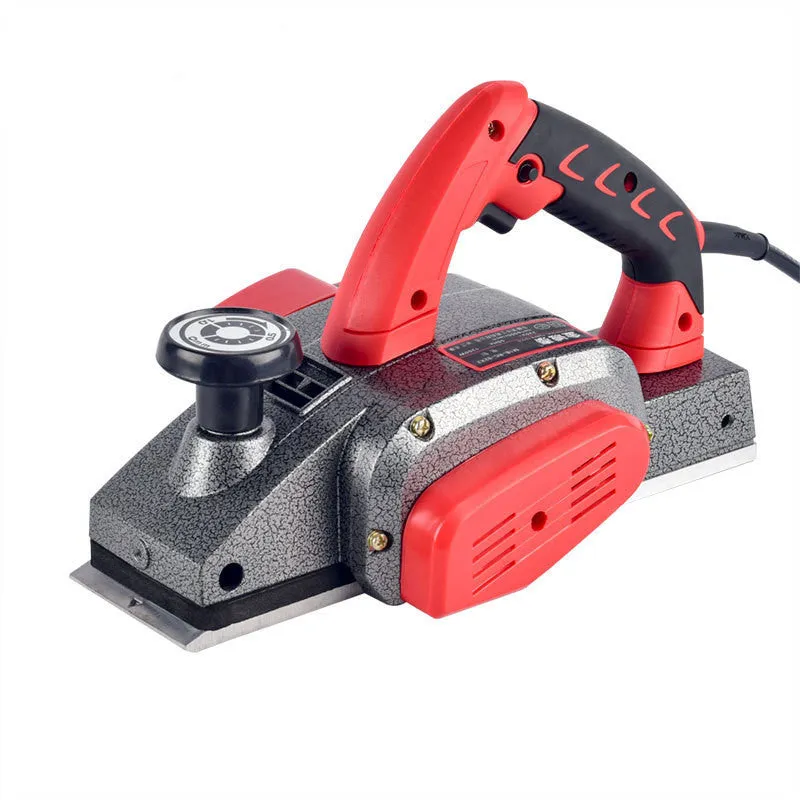 Red aluminium electric wood planer with 82mm width on workbench