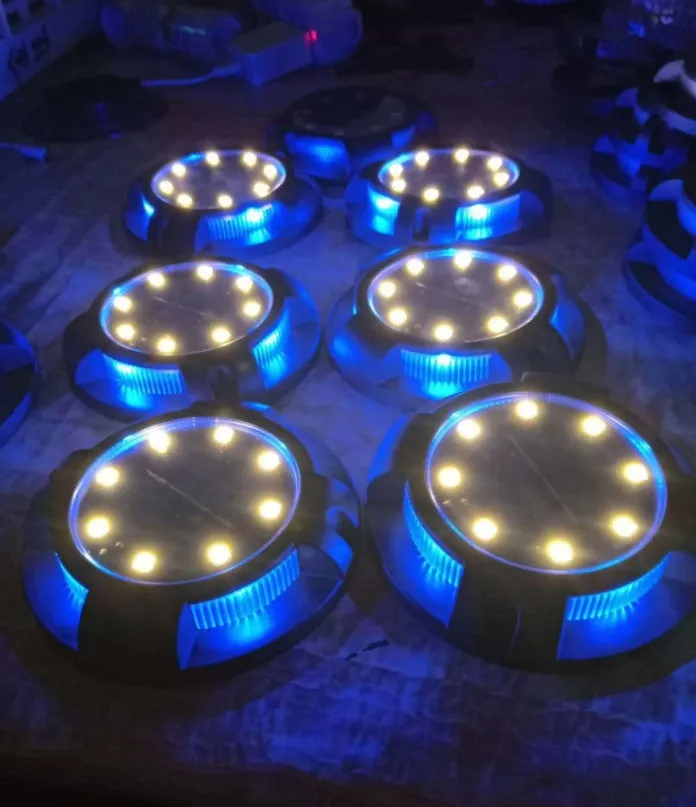LED solar underground lawn light 11x4x13cm black ABS PP with seven colour changing cold white light on grass at dusk