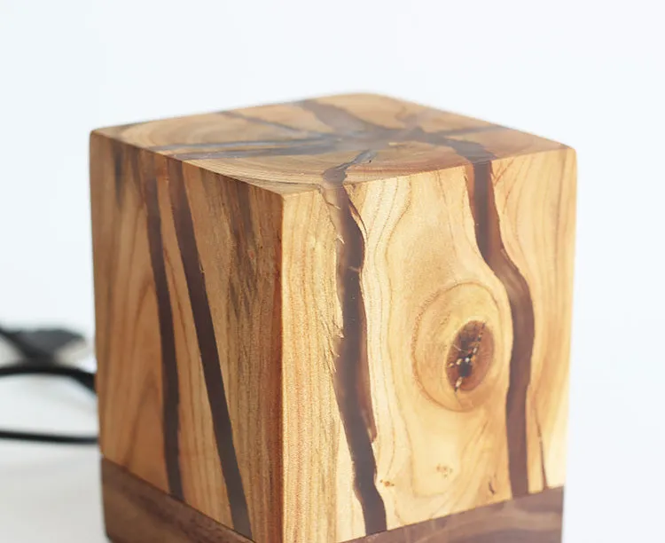 Creative crack night lamp in wood and PMMA with USB cable on bedside table