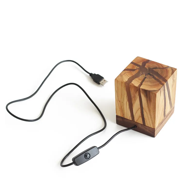 Creative crack night lamp in wood and PMMA with USB cable on bedside table