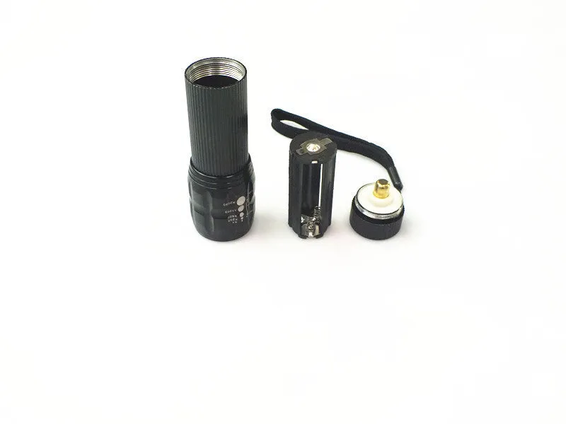 Black mini LED flashlight with telescopic head and tail push button switch on plain background