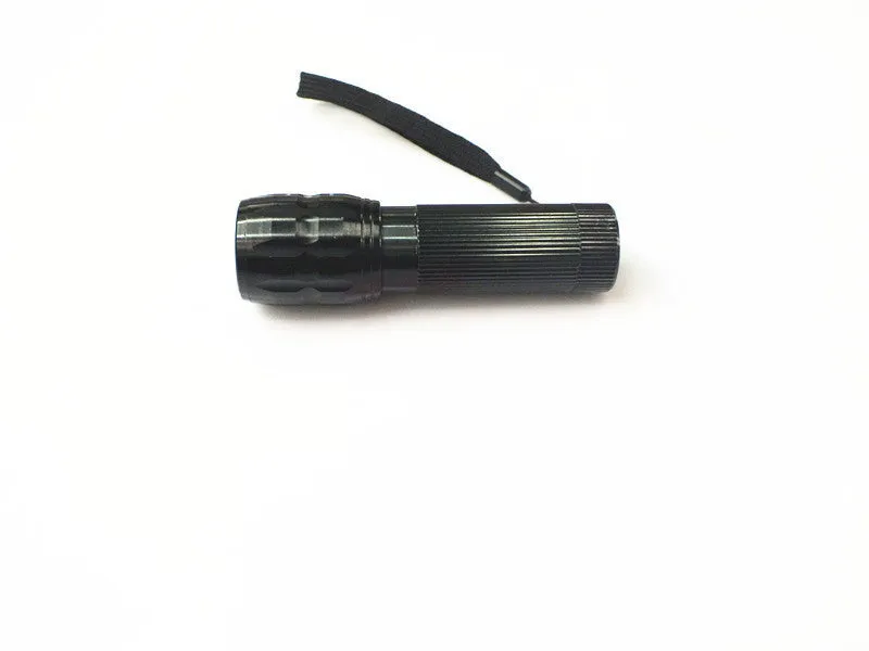 Black mini LED flashlight with telescopic head and tail push button switch on plain background