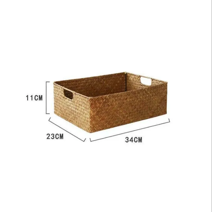 Handmade straw woven rectangular storage basket in natural grass fibre on a shelf