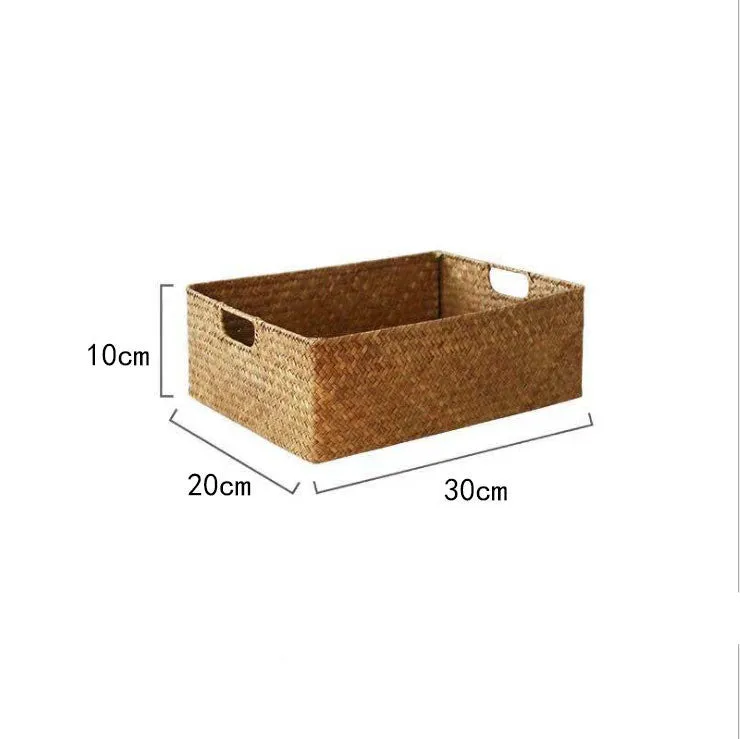 Handmade straw woven rectangular storage basket in natural grass fibre on a shelf