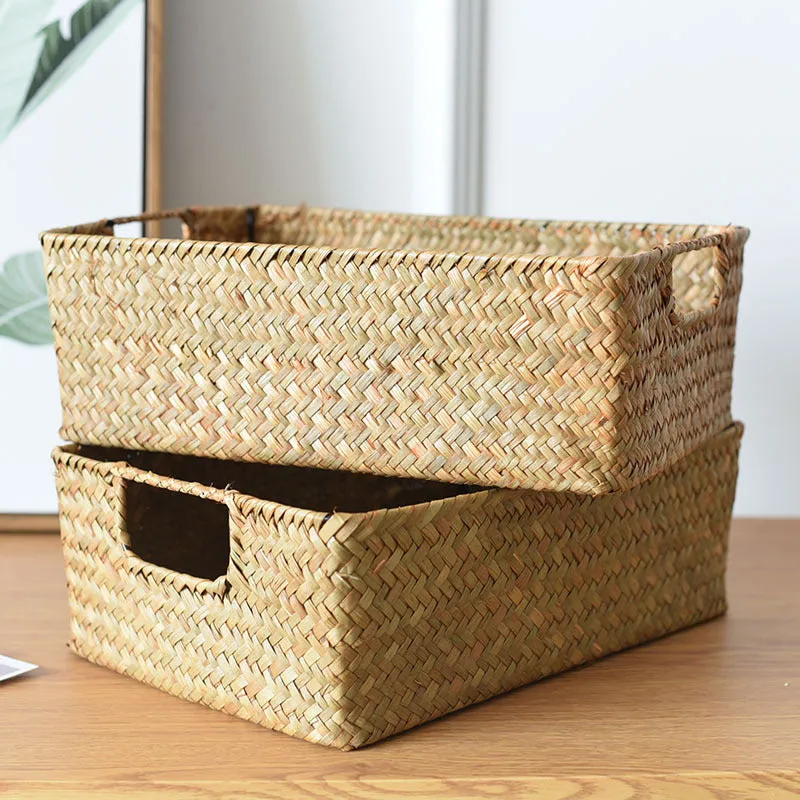 Handmade straw woven rectangular storage basket in natural grass fibre on a shelf