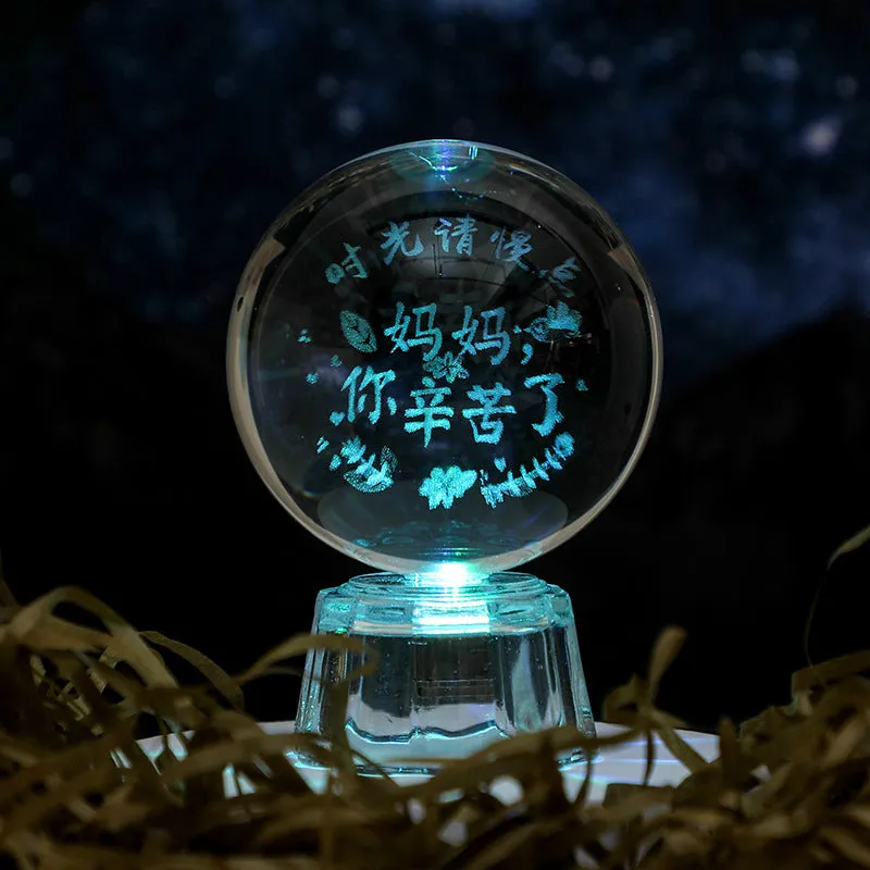 Transparent white crystal ball ornament with inner carving on a fixed base.