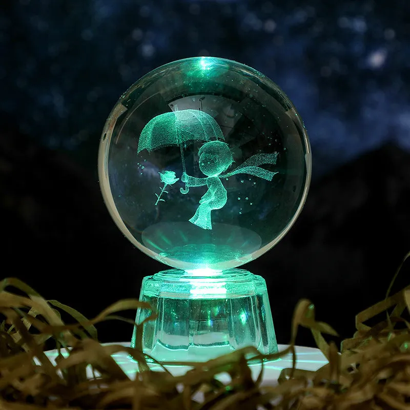 Transparent white crystal ball ornament with inner carving on a fixed base.