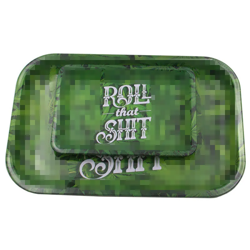 Green metal cigarette tray with maple leaf pattern, 18 x 12.5 cm tinplate ashtray on table