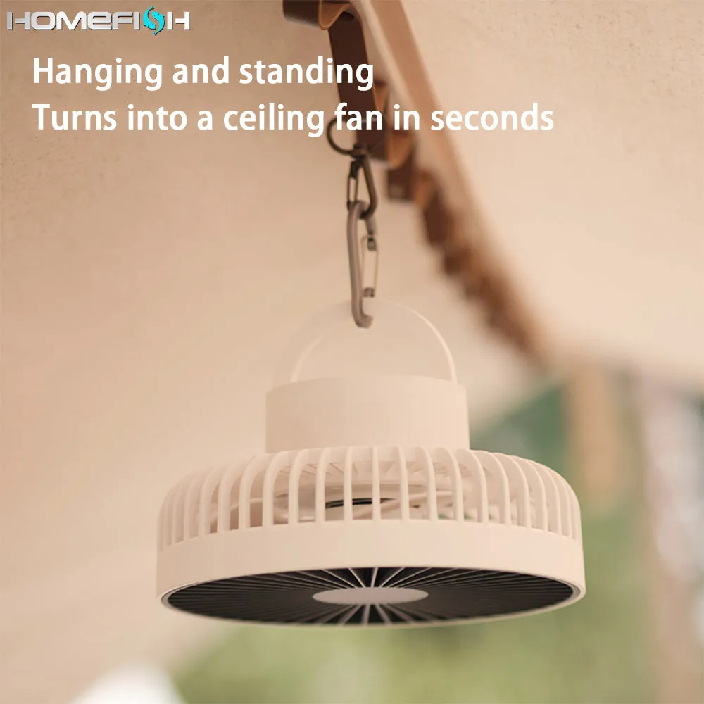 Tripod camping fan in dark grey on a wooden table showing blades and USB port