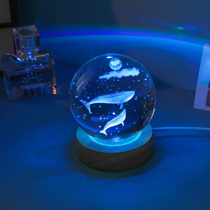 Colorful luminous crystal ball on light wooden base with data cable