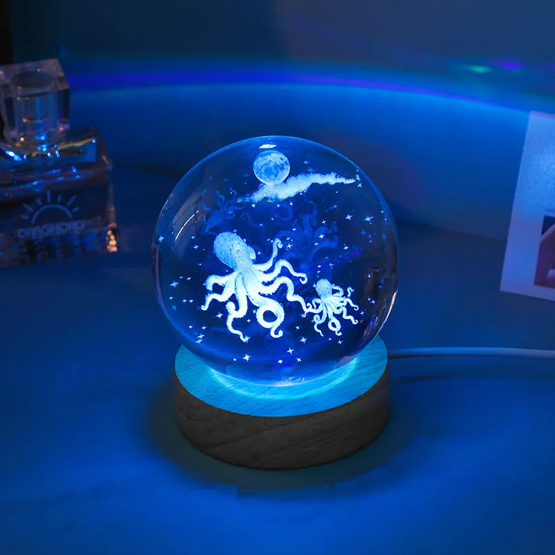 Colorful luminous crystal ball on light wooden base with data cable