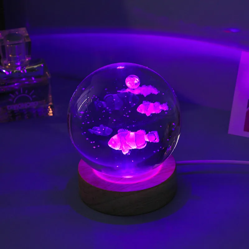 Colorful luminous crystal ball on light wooden base with data cable