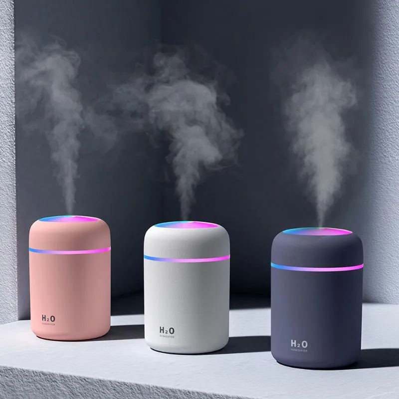 Car USB cup air humidifier with 300ml tank, two spray modes, colourful atmosphere light, in pink colour on desk