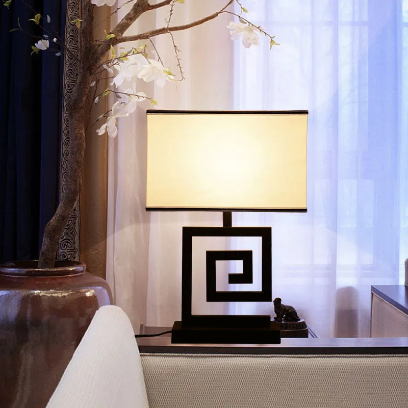 Retro modern Chinese table lamp with fabric lampshade and iron base on wooden side table
