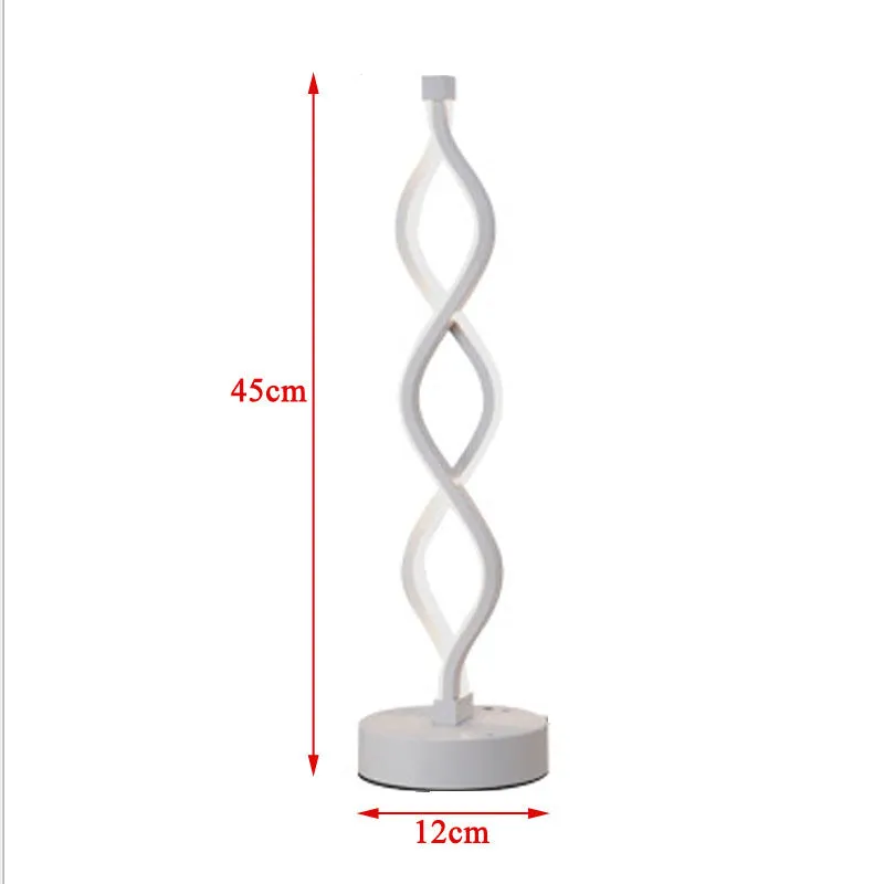 Modern LED desk lamp with aluminium metal body and acrylic mask, gold colour, on a desk