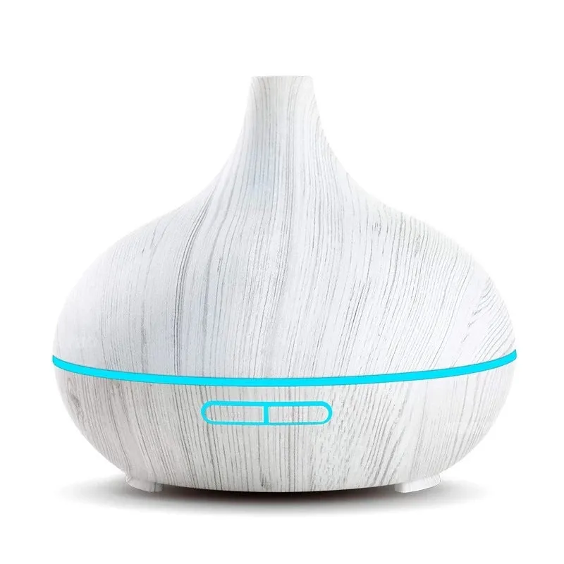 Round 550ml ultrasonic aromatherapy humidifier in white with mechanical control on desk