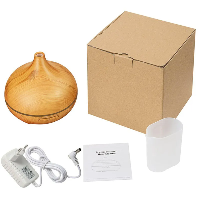 Round 550ml ultrasonic aromatherapy humidifier in white with mechanical control on desk