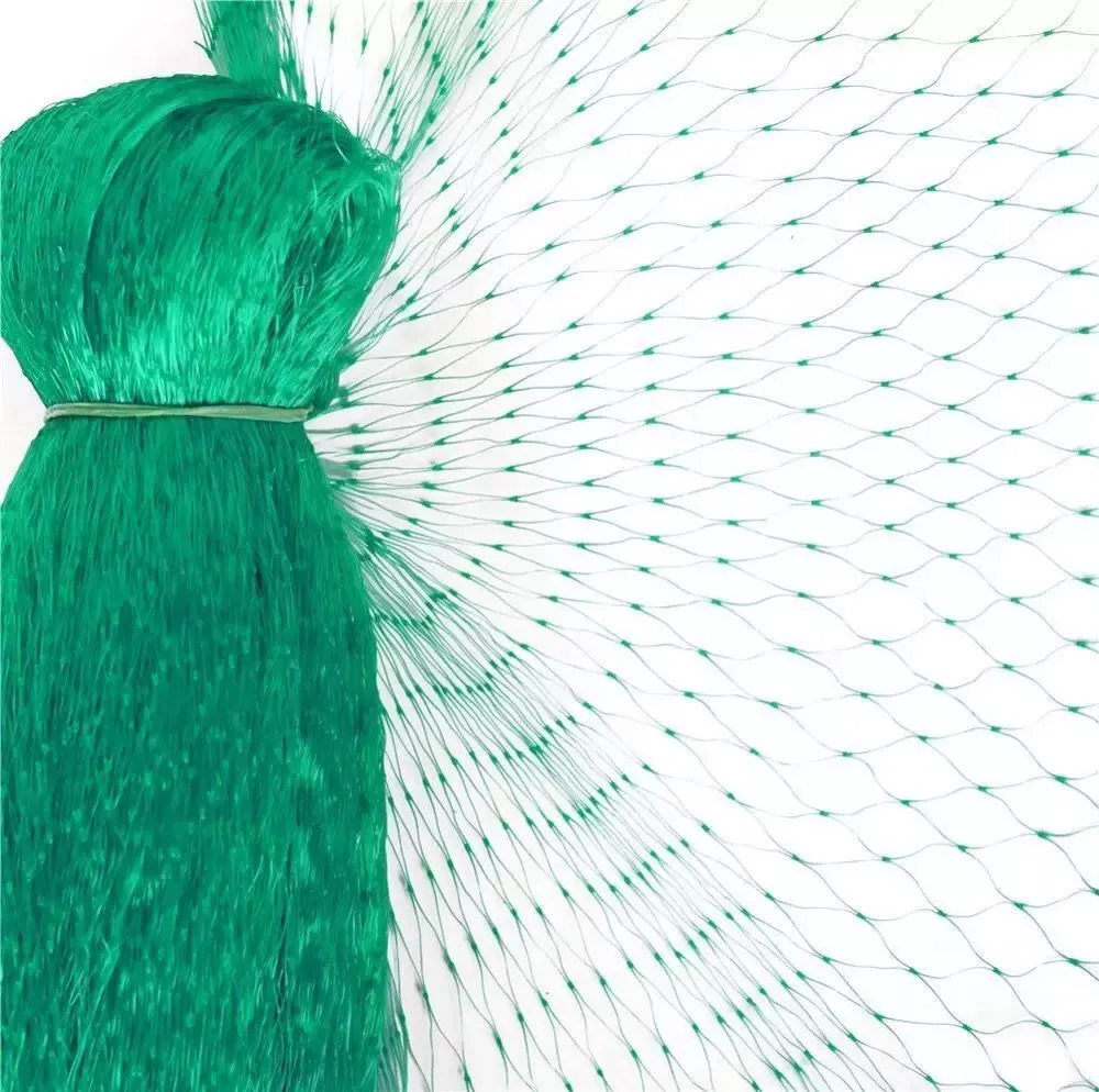 Green polypropylene garden bird net draped over a fruit tree for anti-bird protection
