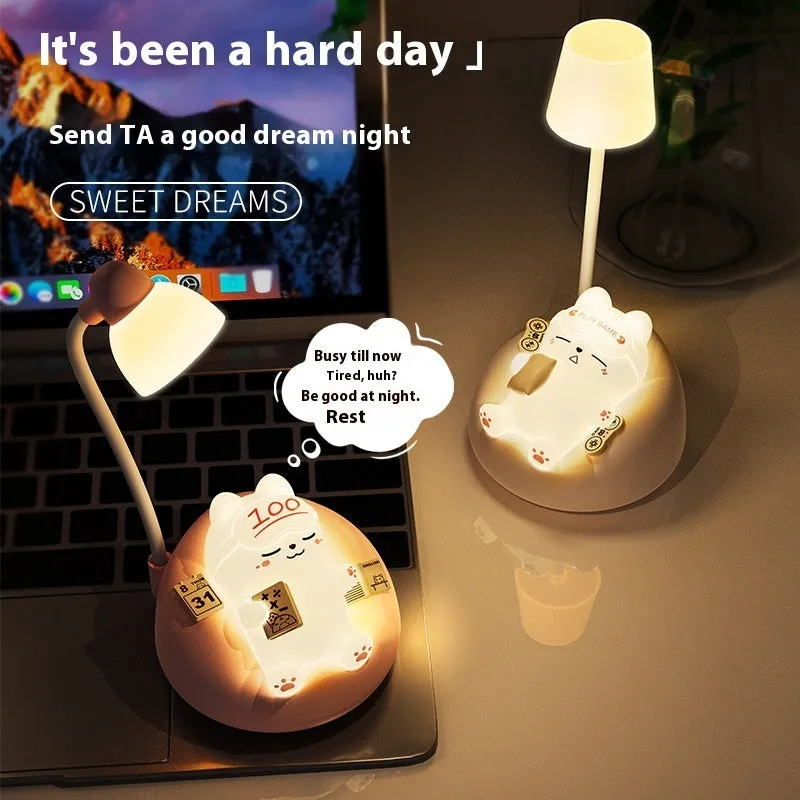Sleeping cat shaped small night lamp in pink with USB charging cable on bedside table