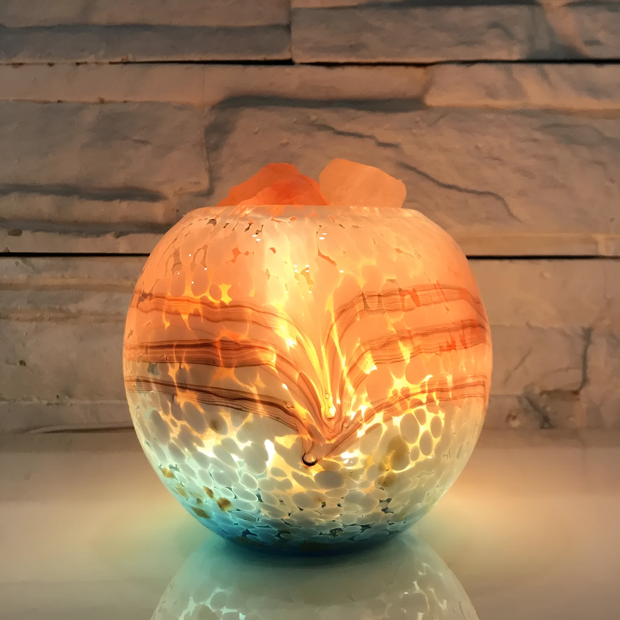 Glass night light with USB cable on a wooden bedside table, 13cm height and width