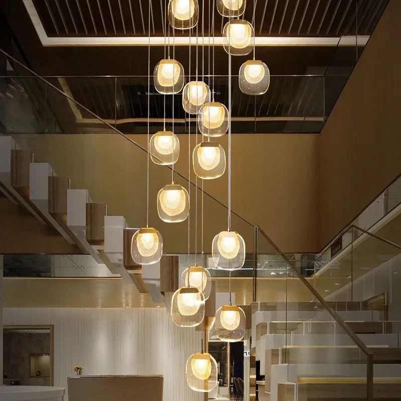 Postmodern crystal chandelier with six gold heads, stainless steel chassis, and adjustable cable on a ceiling