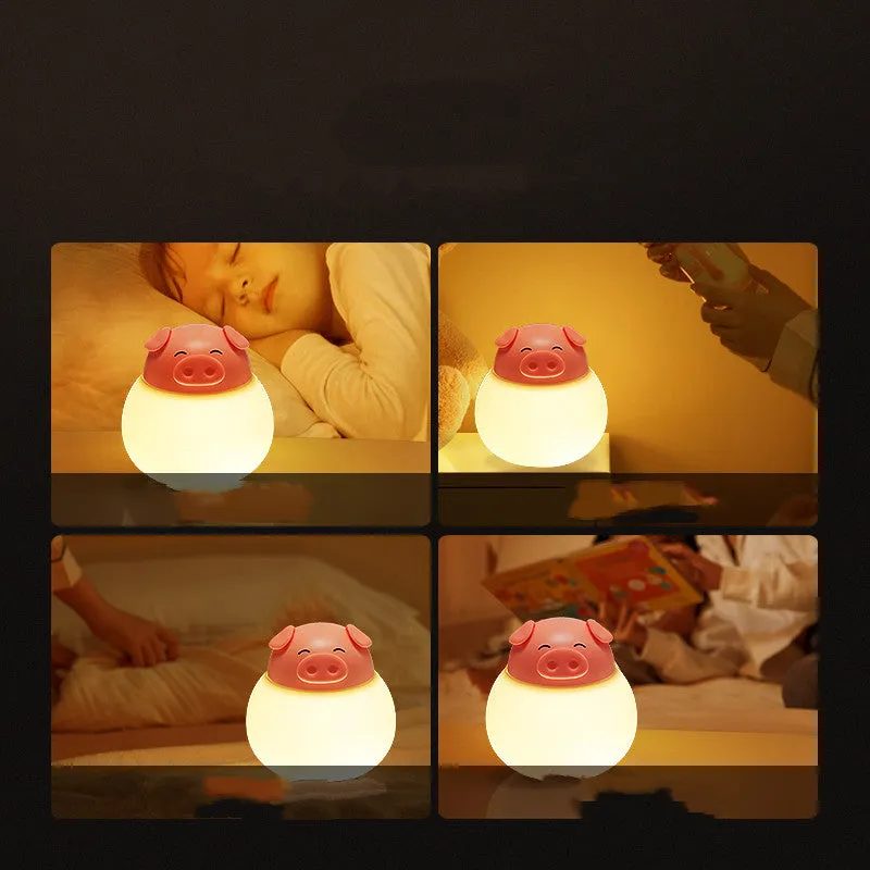Pink pig silicone pat bedside lamp with USB LED light source on a table
