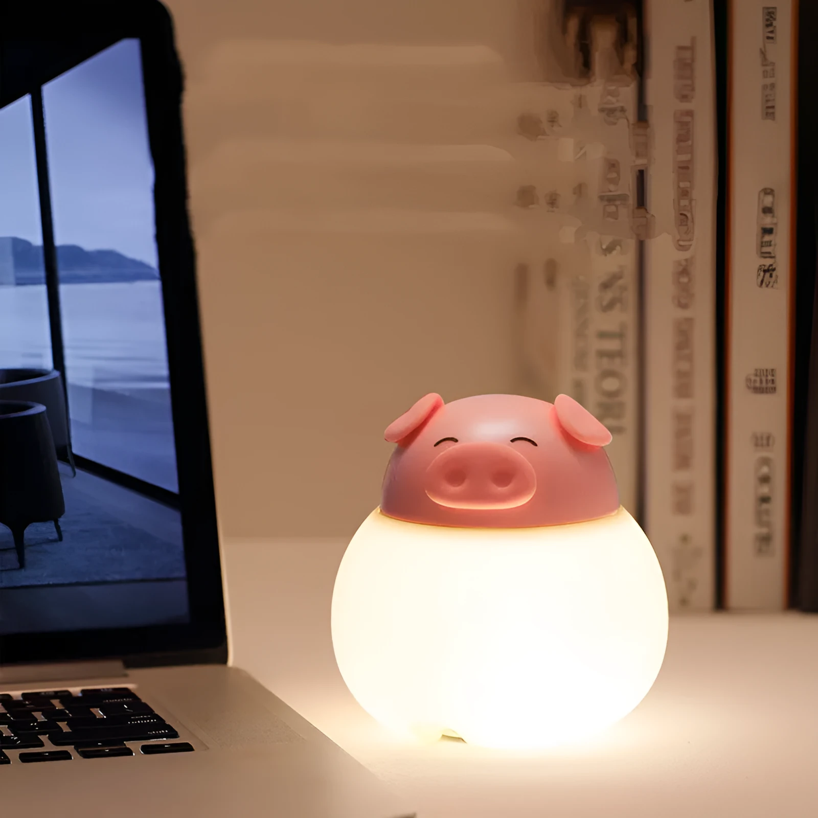 Pink pig silicone pat bedside lamp with USB LED light source on a table
