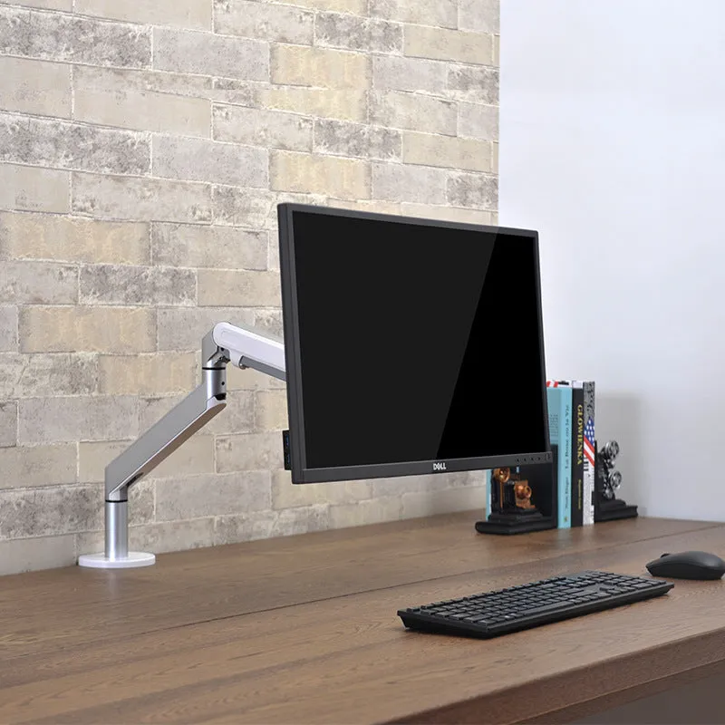 Adjustable lifting computer monitor stand in silver on a desk with a screen placed on top