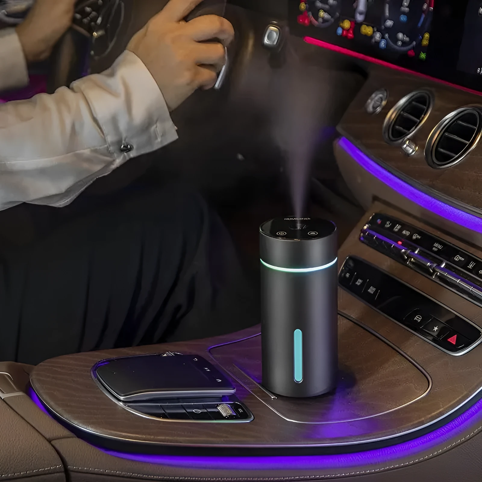 Black portable car humidifier and essential oil diffuser with aluminium body and colourful night light on