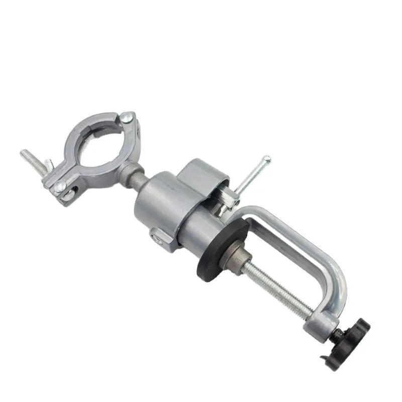 Clamp-on bench vise with a 360-degree rotating head and bracket pliers on a workbench.