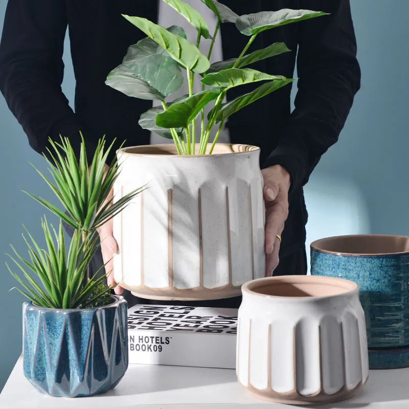 Nordic simple striped ceramic flower pot in white, 14x13cm size, on a desktop with a small plant
