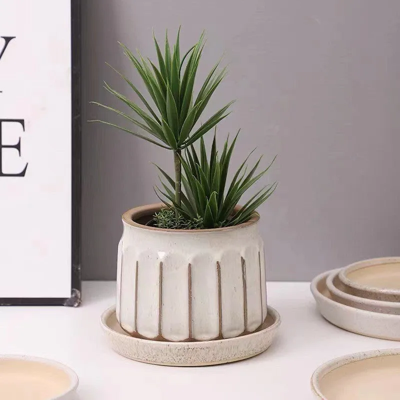 Nordic simple striped ceramic flower pot in white, 14x13cm size, on a desktop with a small plant
